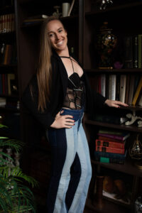 Smiling Evansville, Indiana boudoir photographer standing in her luxury photography studio.