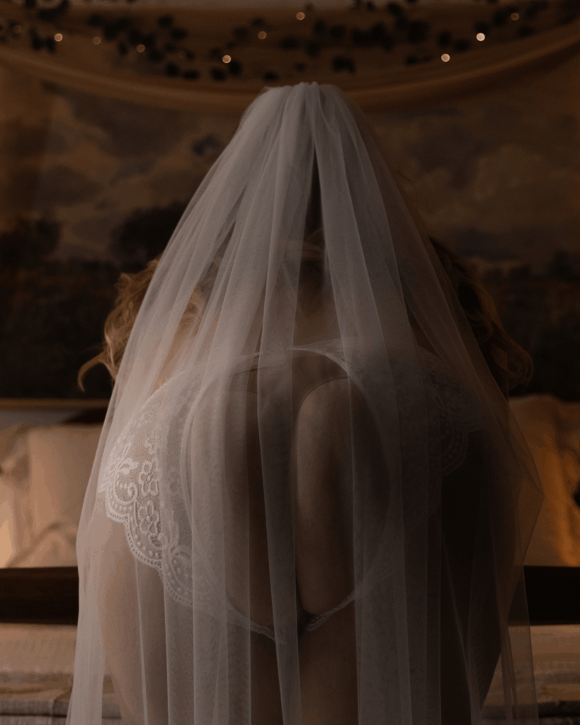 Bride wearing a wedding veil during a bridal boudoir photography session in Evansville, Indiana.