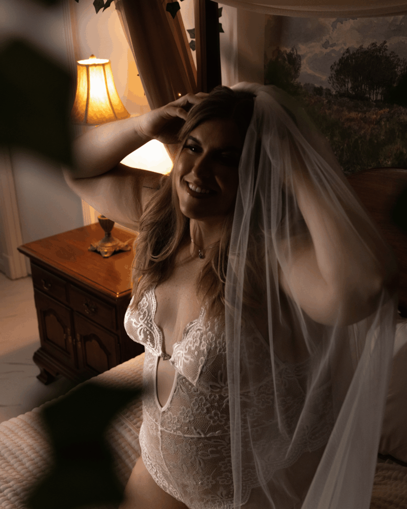 Bride smiling beneath her wedding veil during a bridal boudoir session in Evansville, Indiana.
