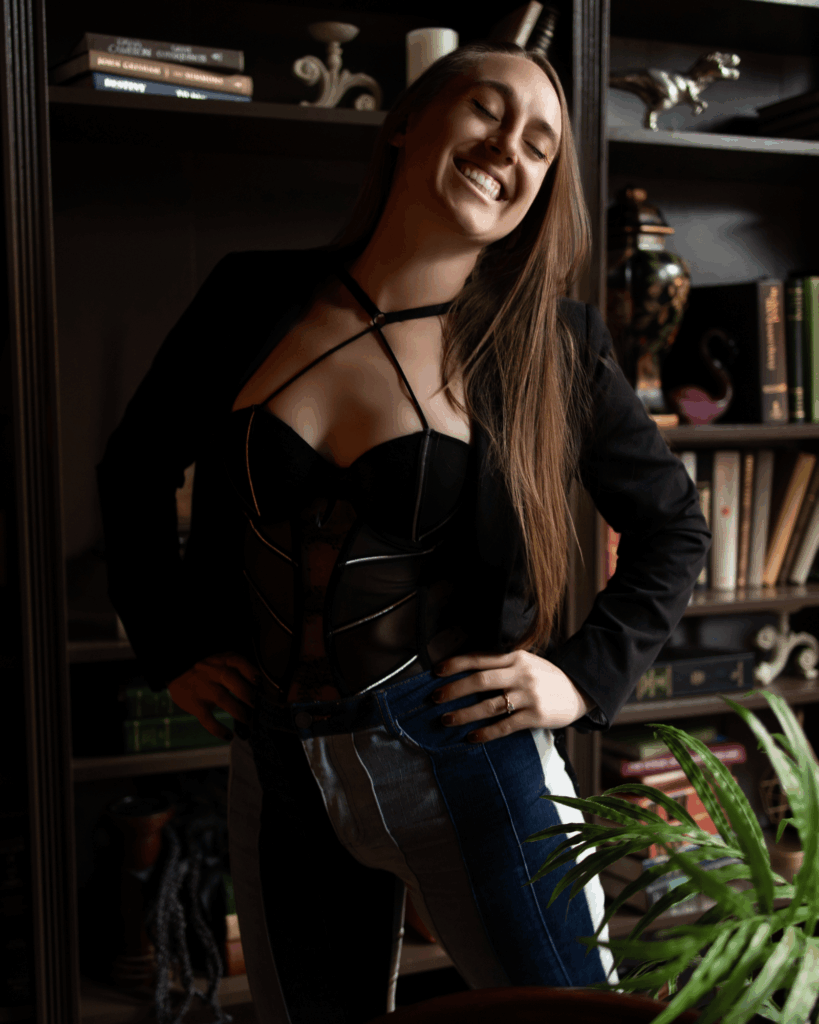 Julia, owner of Boudoir with Jewels, smiling in her private Evansville boudoir studio while welcoming women to The Vault community.